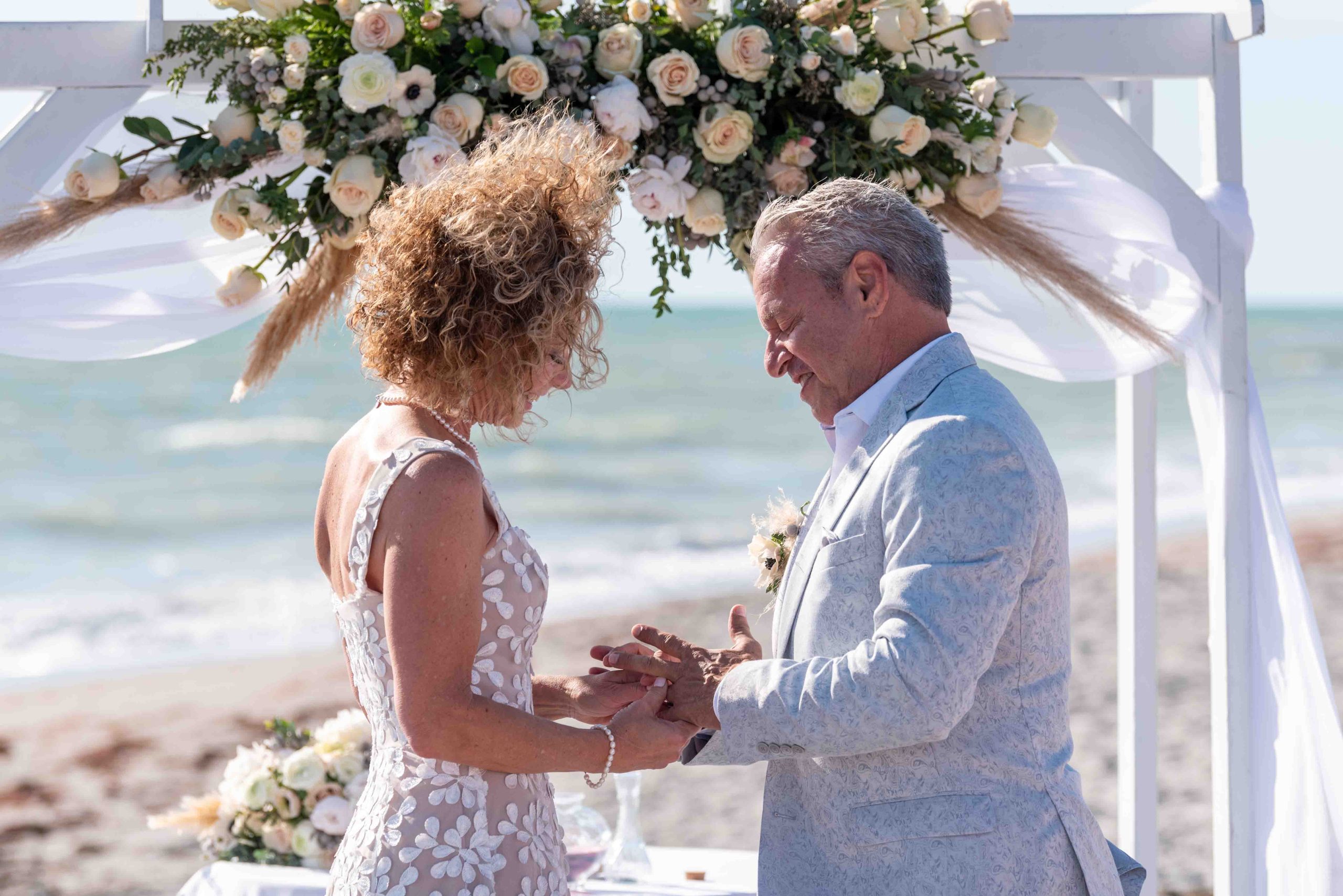 groom puts ring on brides finger