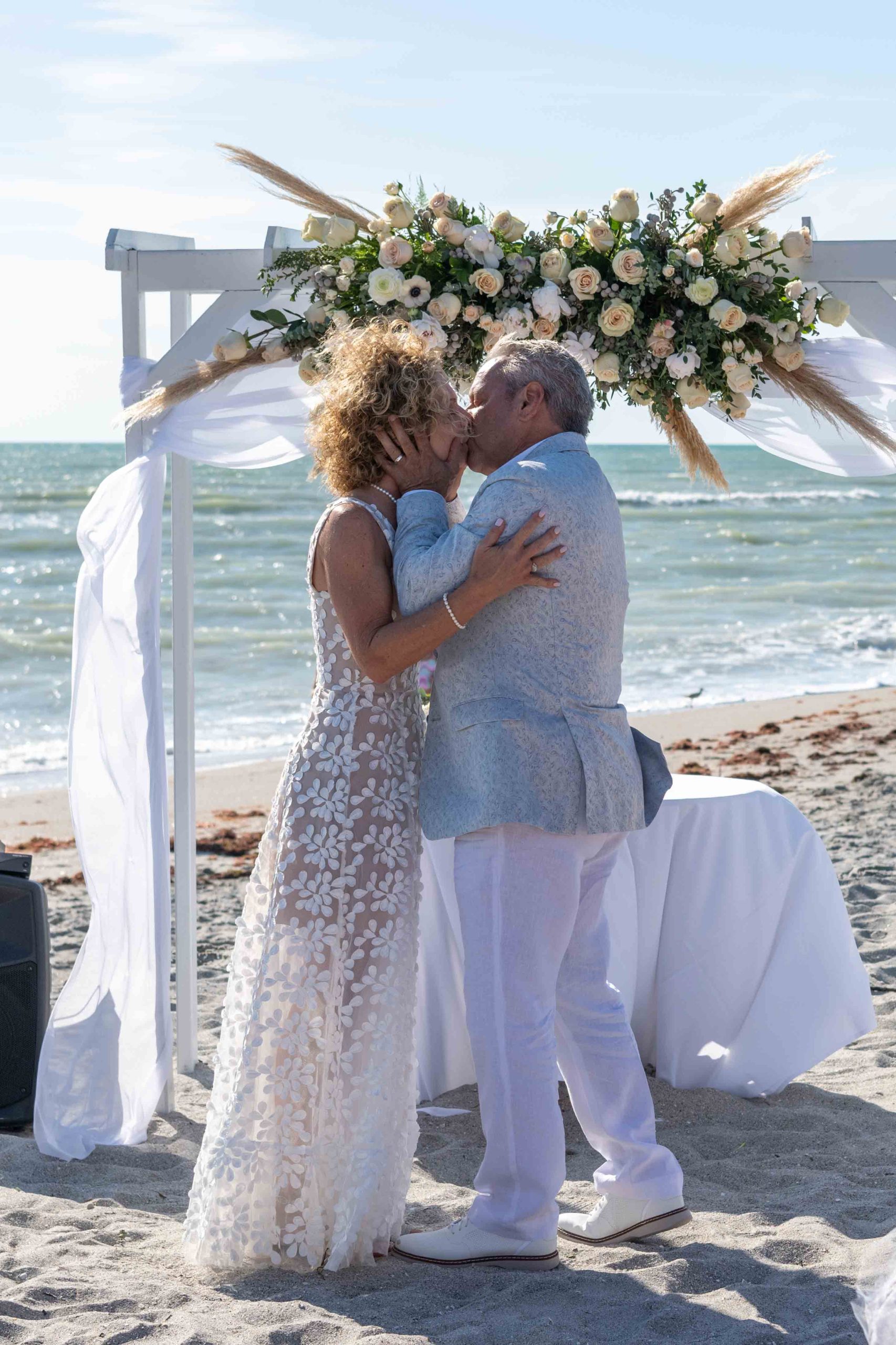 bride and groom share their first kiss after the ceremony on Englewood Beach