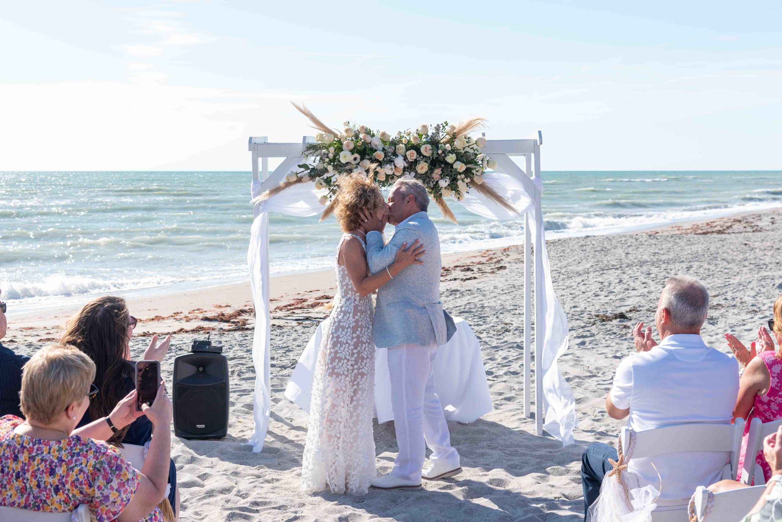 first kiss after wedding ceremony on Englewood Beach