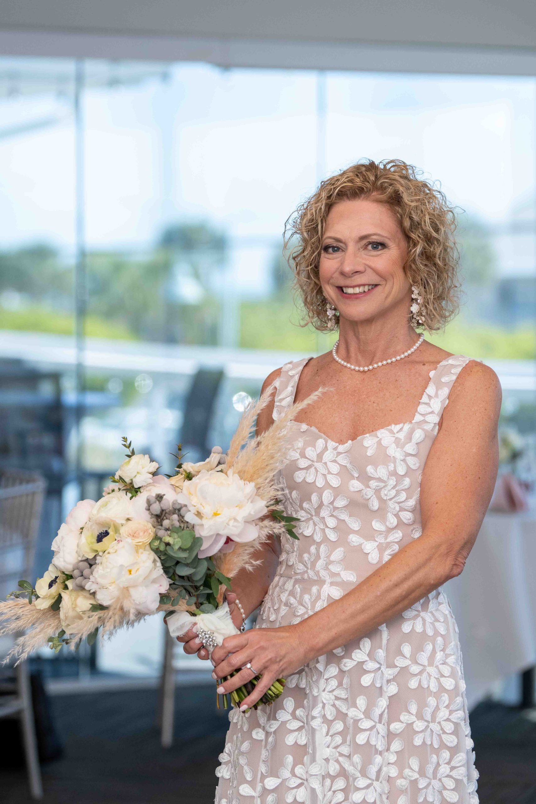 the bride showing off her flowers while in the reception room at The Waverly