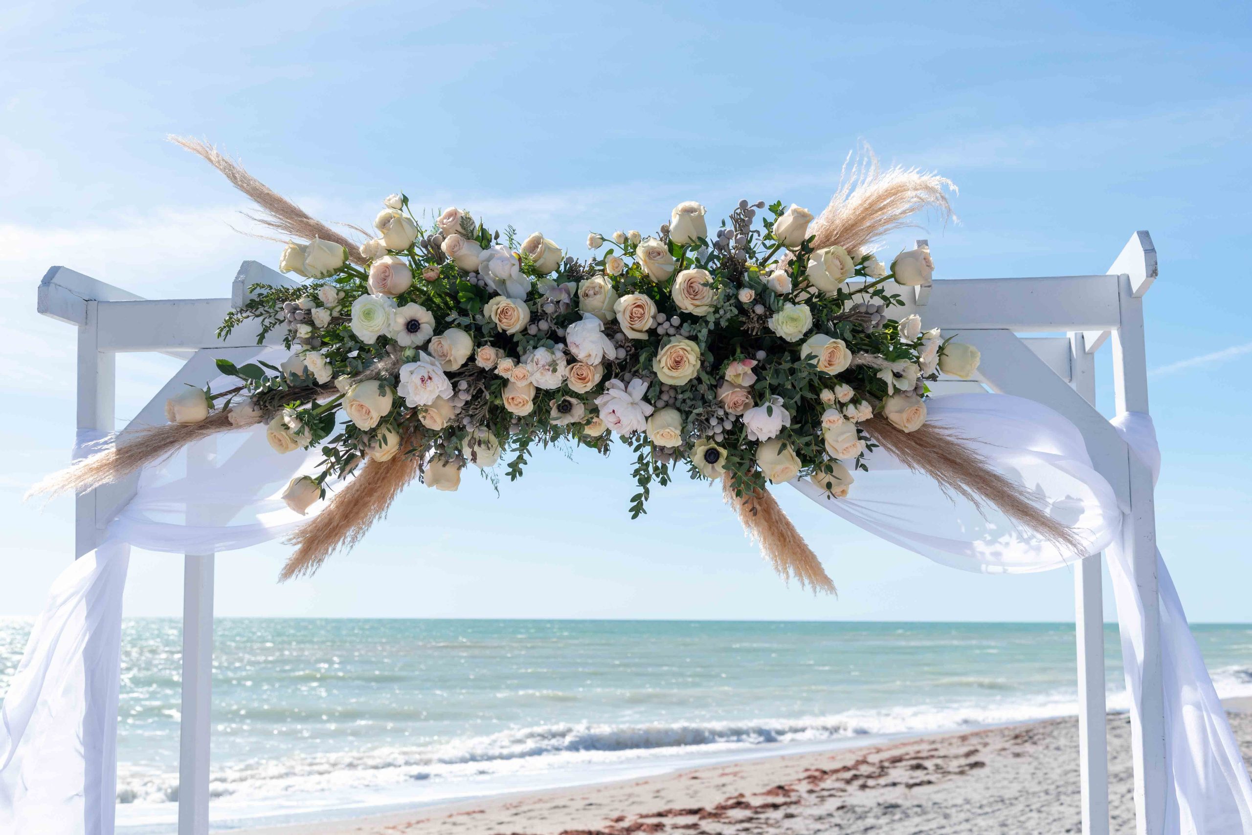 the flowers on the arch at the beach