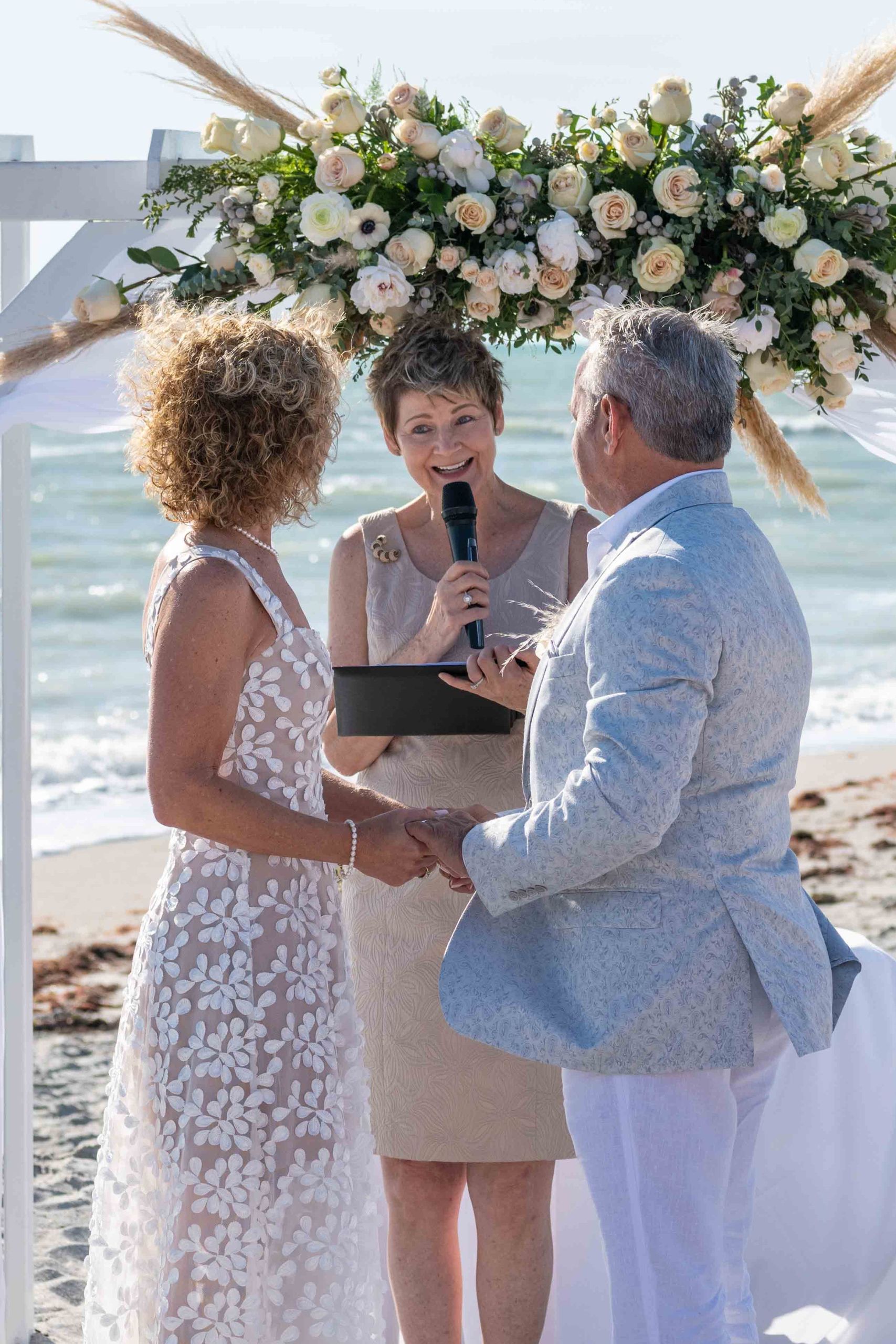 wedding officiant announces them as husband and wife during wedding on Englewood Beach