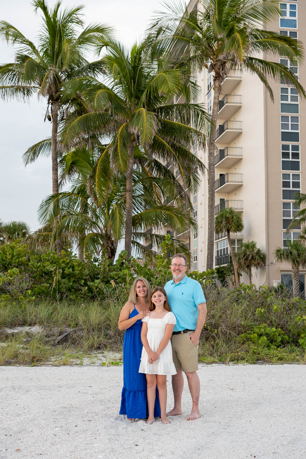 family stands in front of condo on Lido Key
