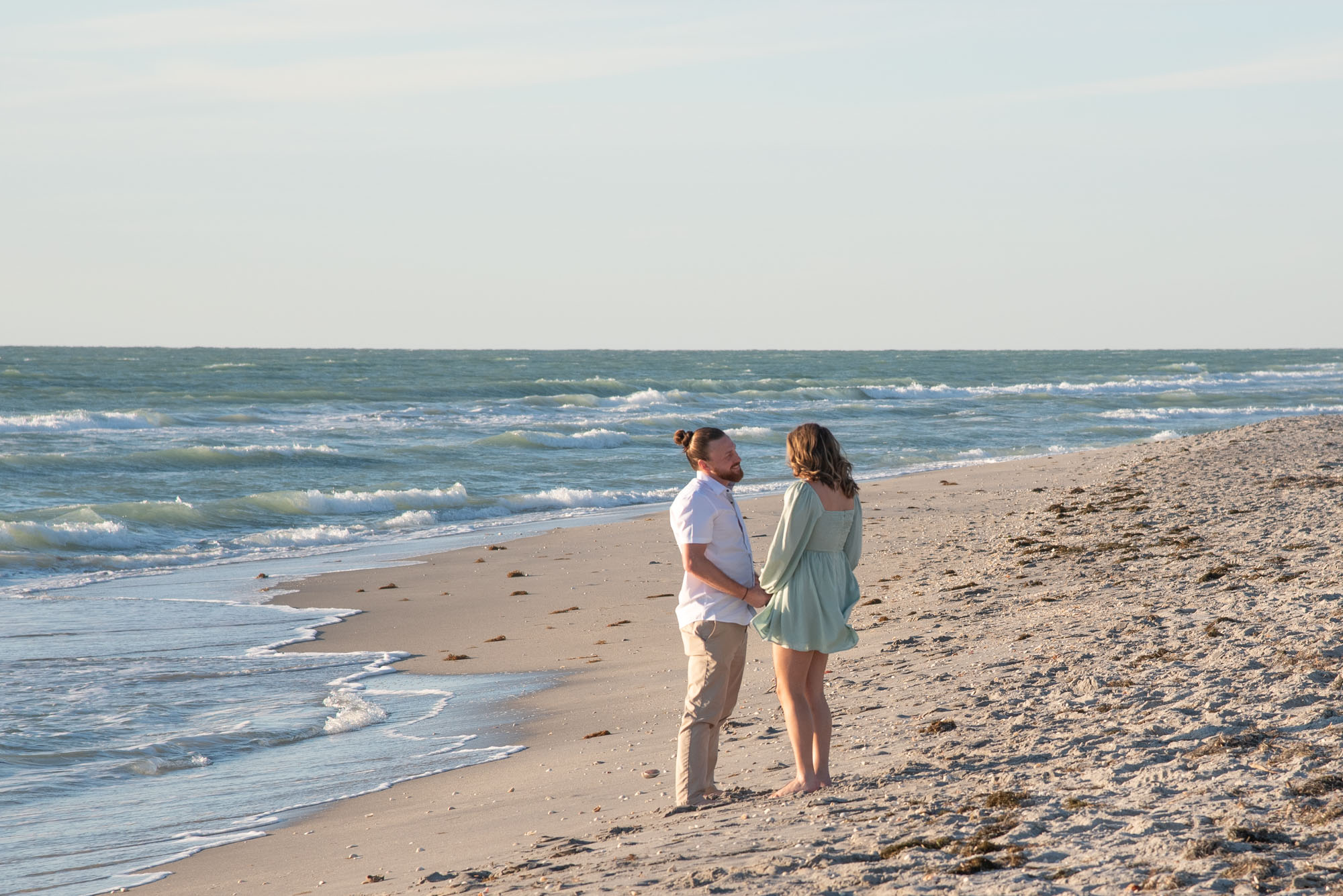guy standing on Englewood Beach talking to girlfriend before he asks for her hand in marriage
