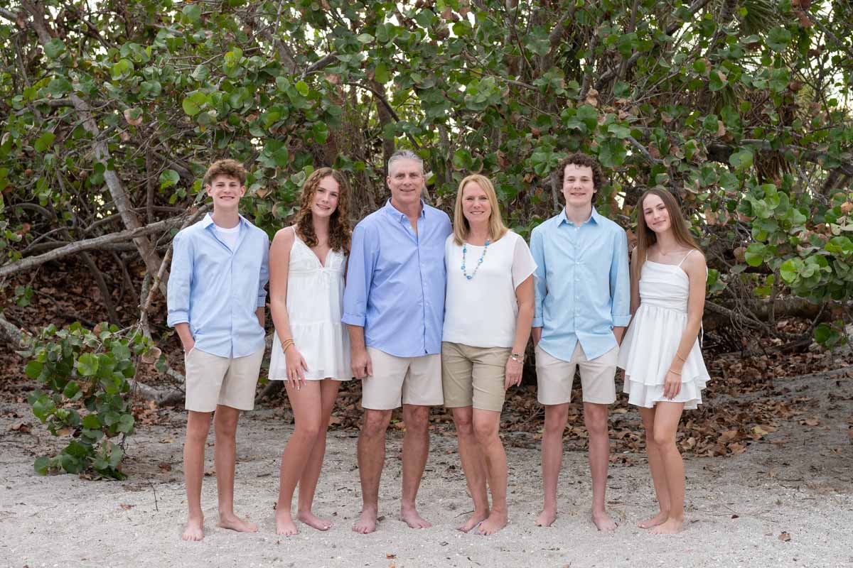 family in front of trees at Manasota Beach
