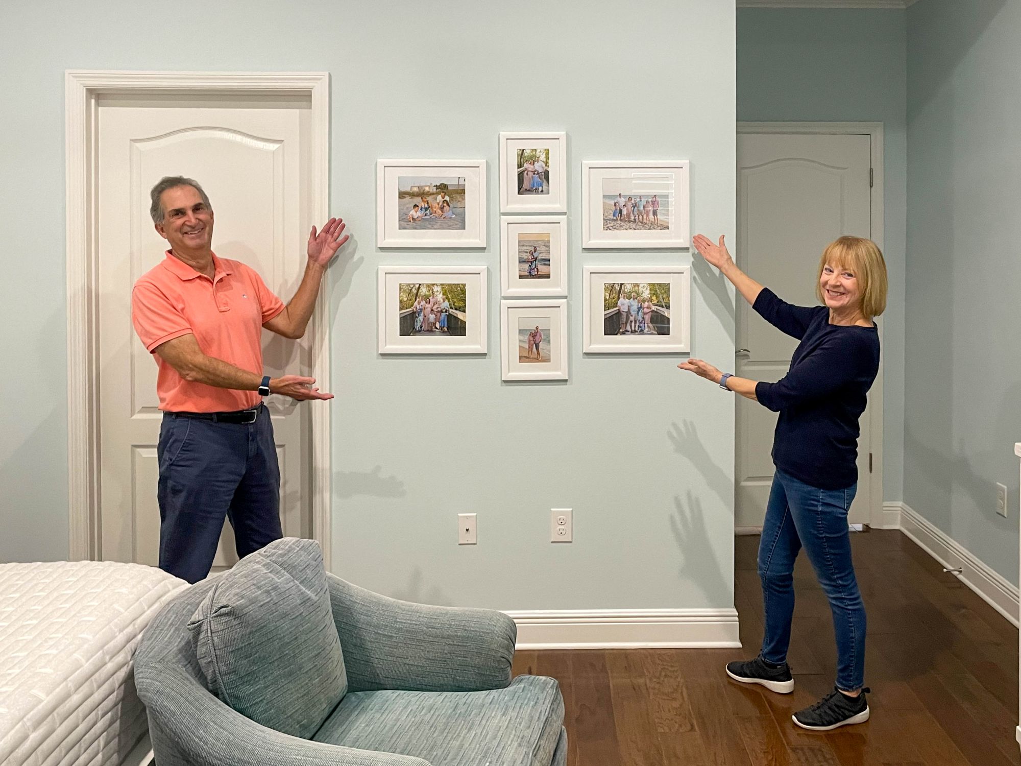 couple showing off their wall collage