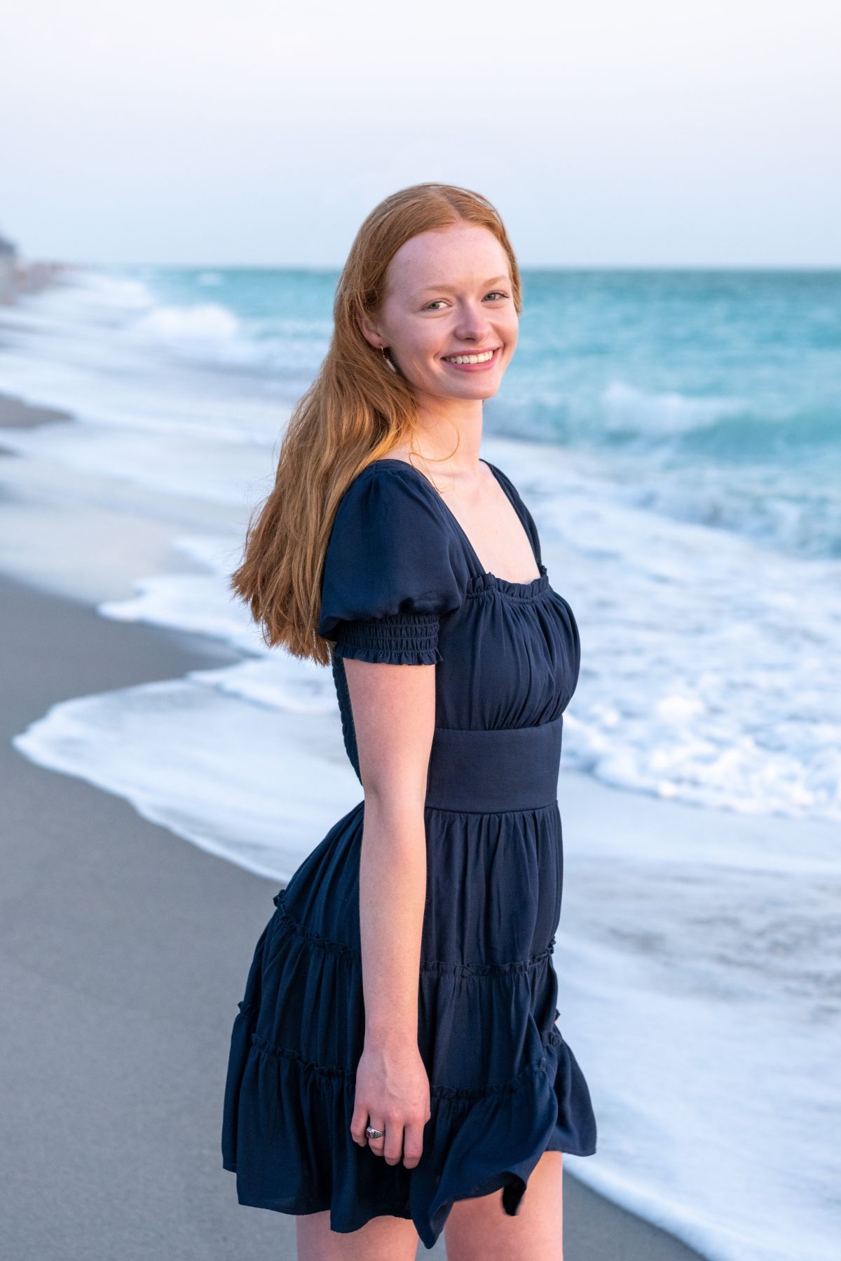 Englewood Senior Session with girl in a blue dress smiling as the sun glows on her face