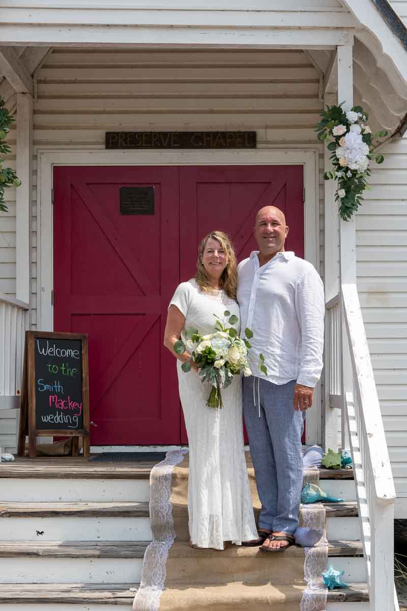 bride and groom on the steps of the chapel on Little Gasparilla Island after their wedding ceremony