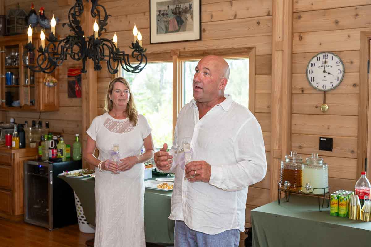 groom gives a toast while his bride looks on