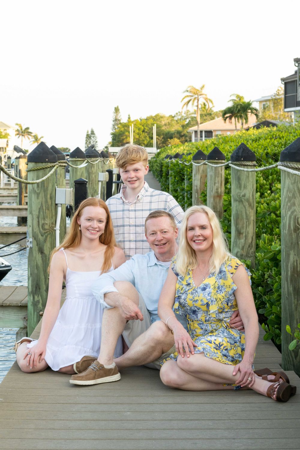 family sitting on a dock at Tamarind Inn on Manasota Key