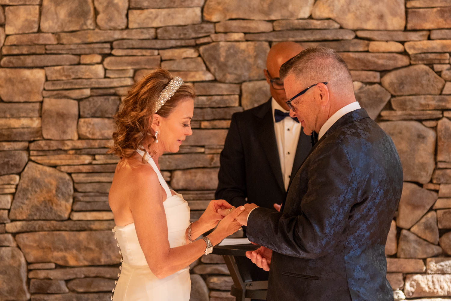 bride puts the groom's ring on