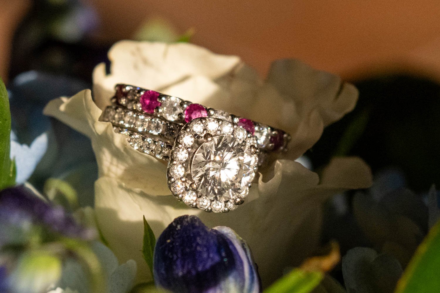 the bride's wedding rings in her floral bouquet
