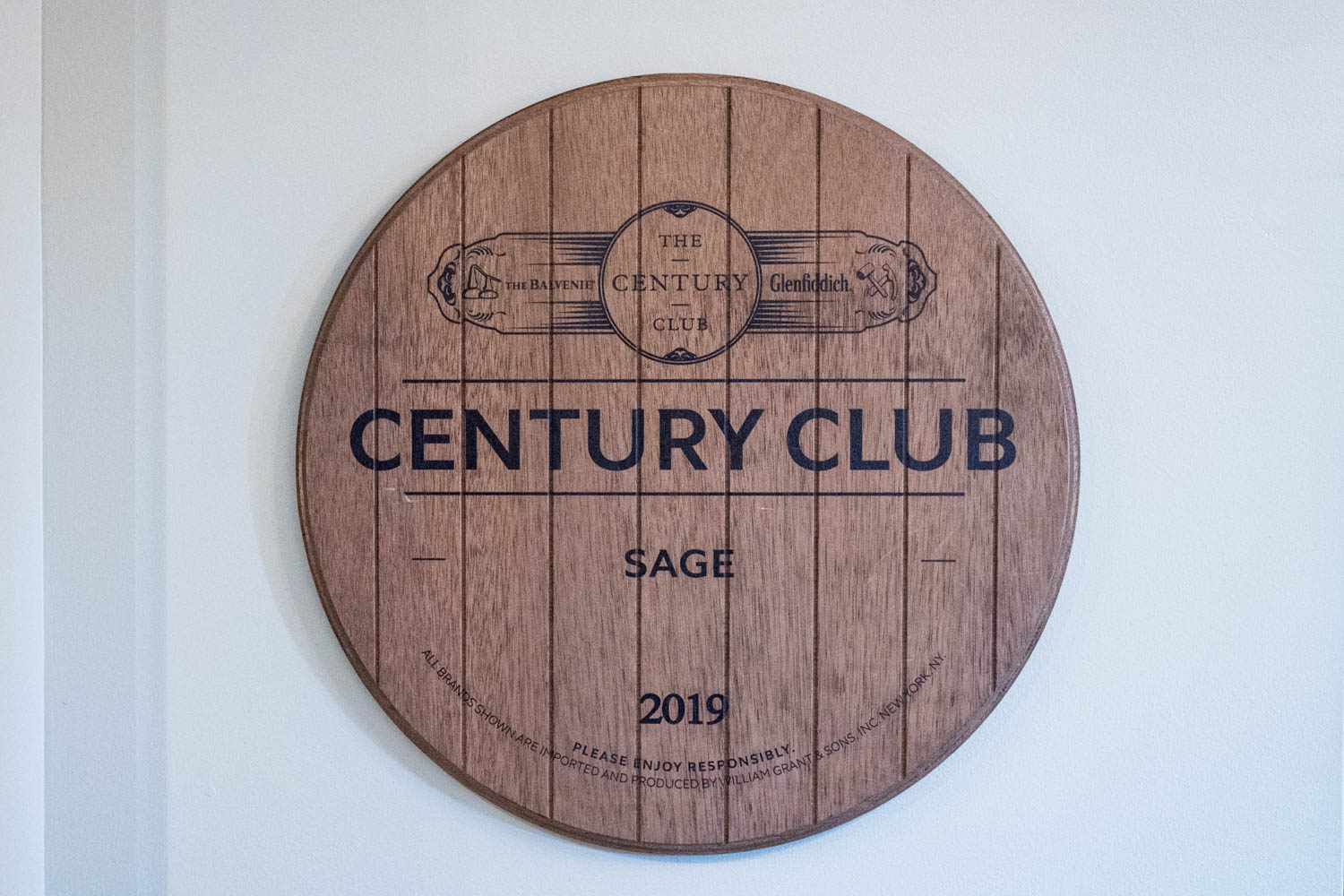 wood sign at Sage Srq that says Century Club