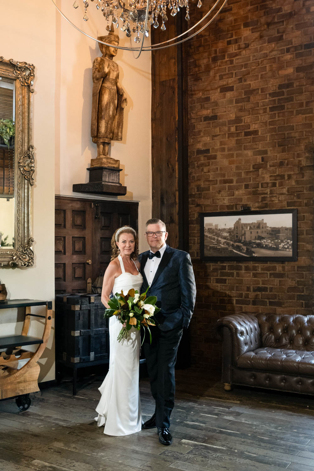 bride and groom stand together in the lobby of Sage SRQ before their wedding