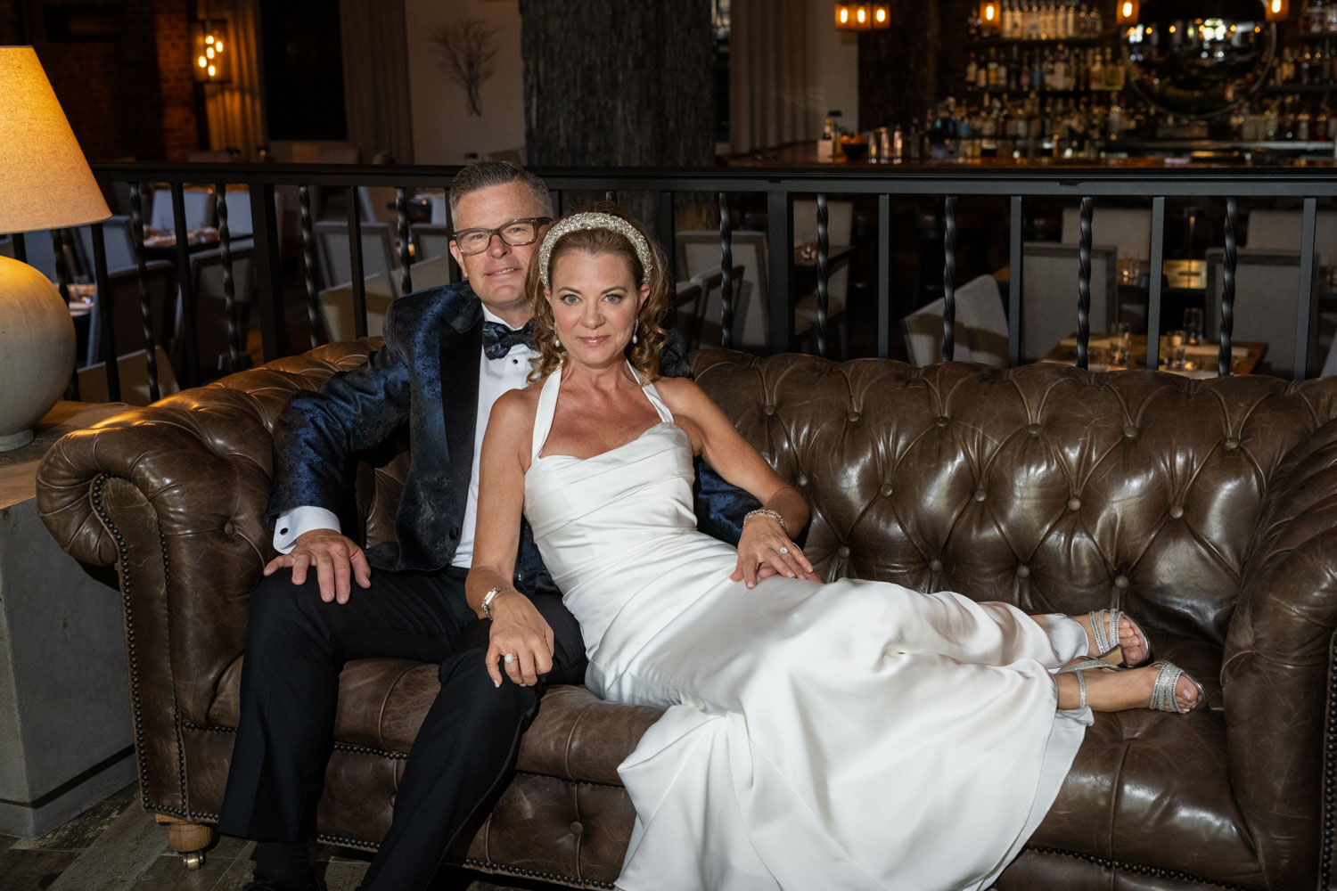 bride and groom sit together on the couch before their wedding at Sage SRQ
