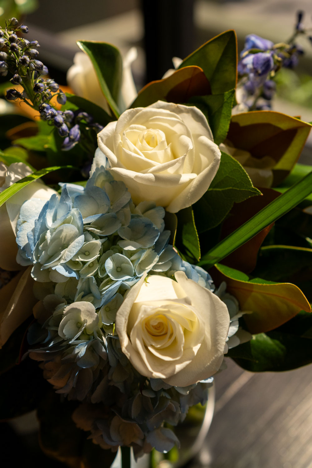 two white roses mixed into the bridal bouquet