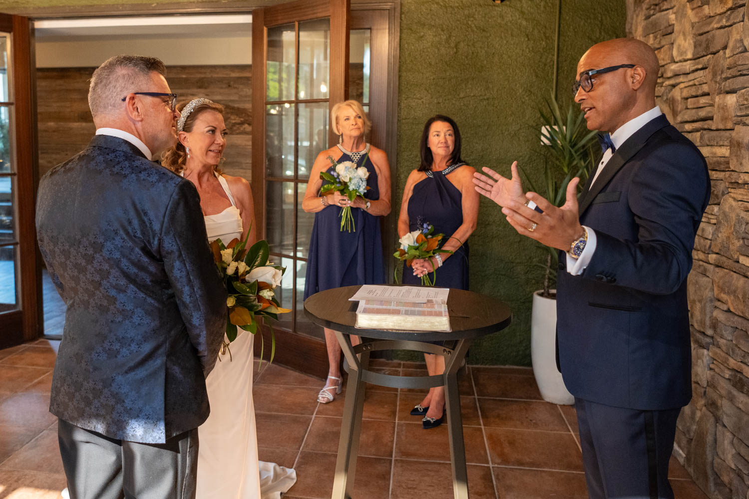 the officiant speaks as the bride and groom look on