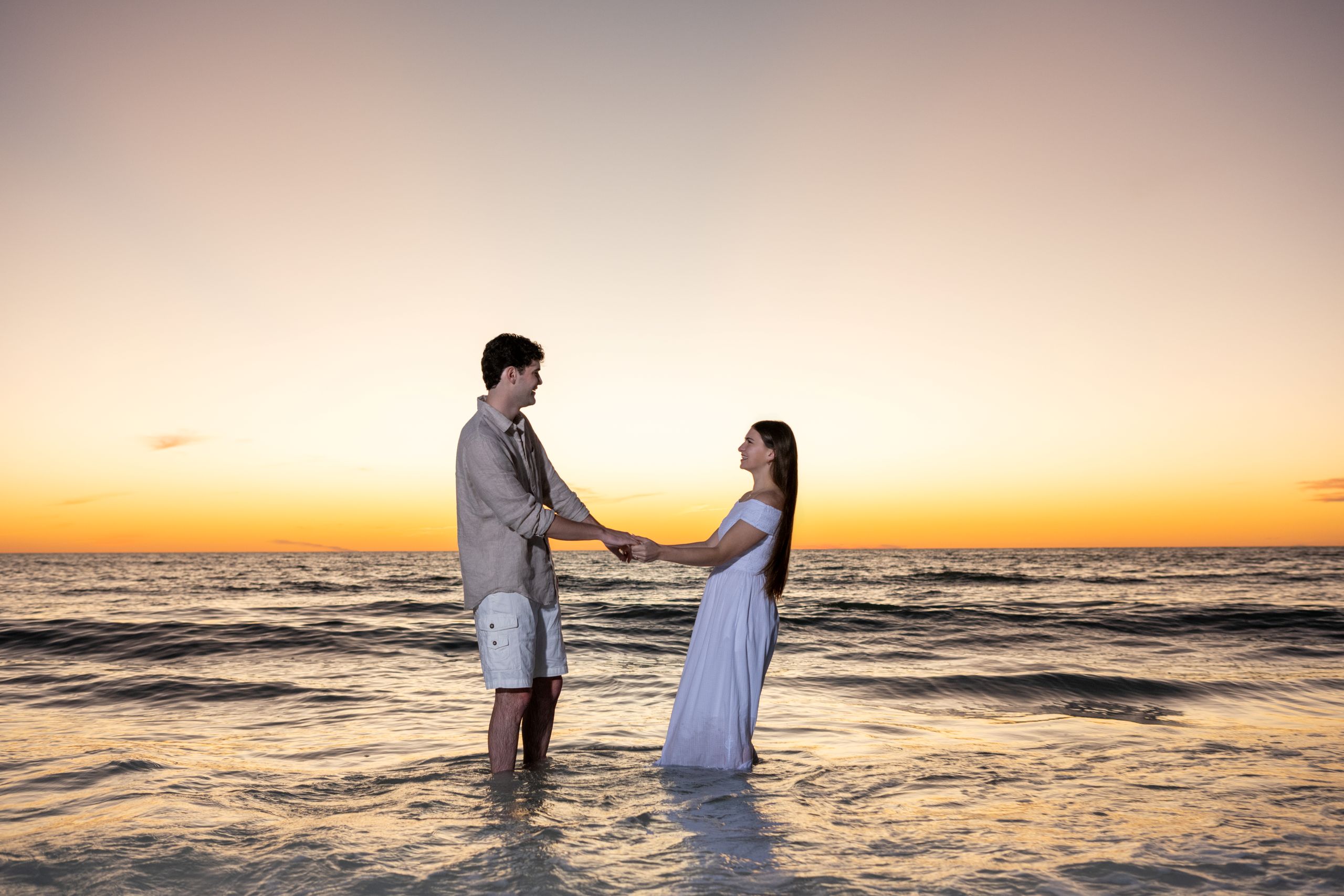 couple dance in the Gulf after sunset