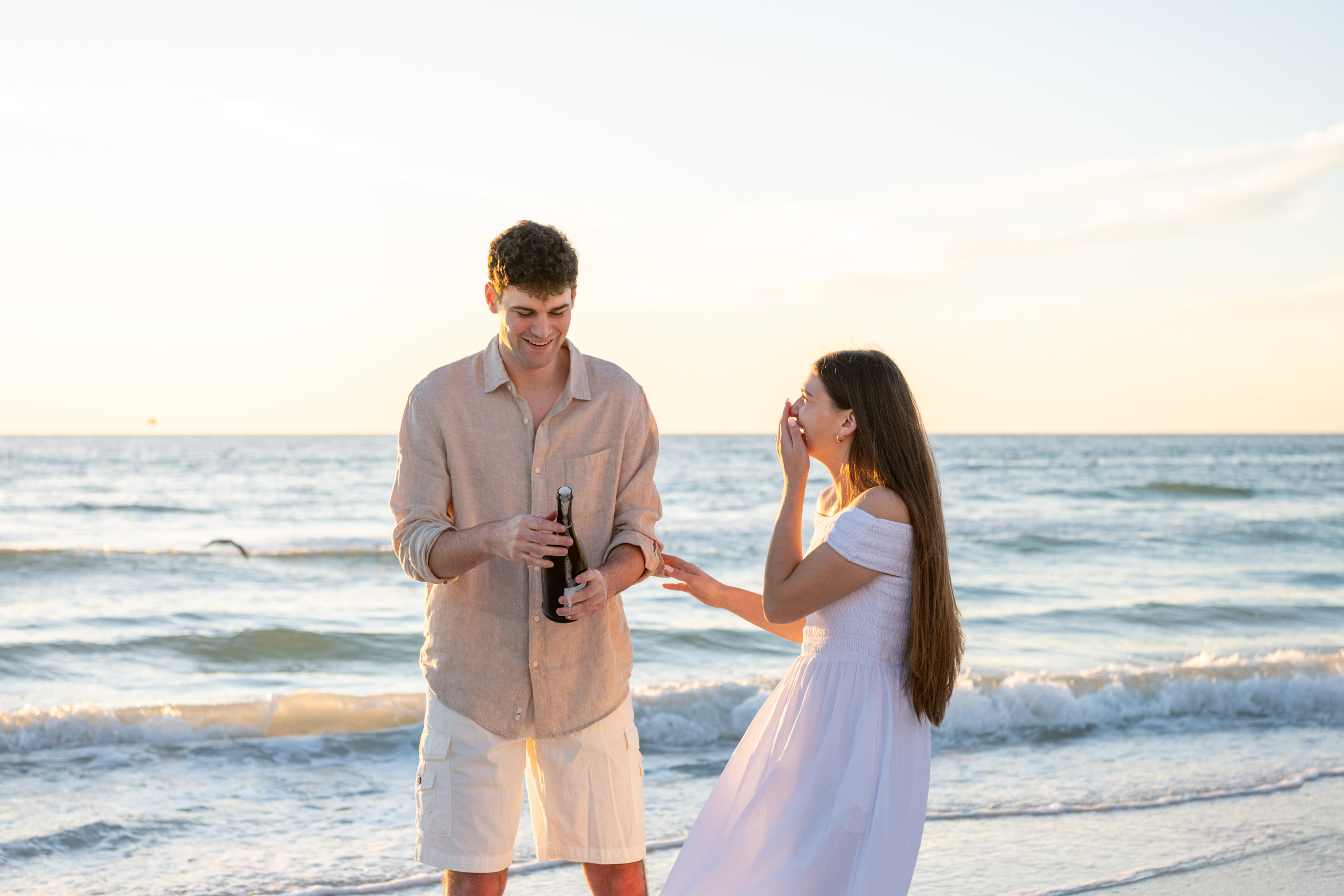 girl laughs after champagne sprays
