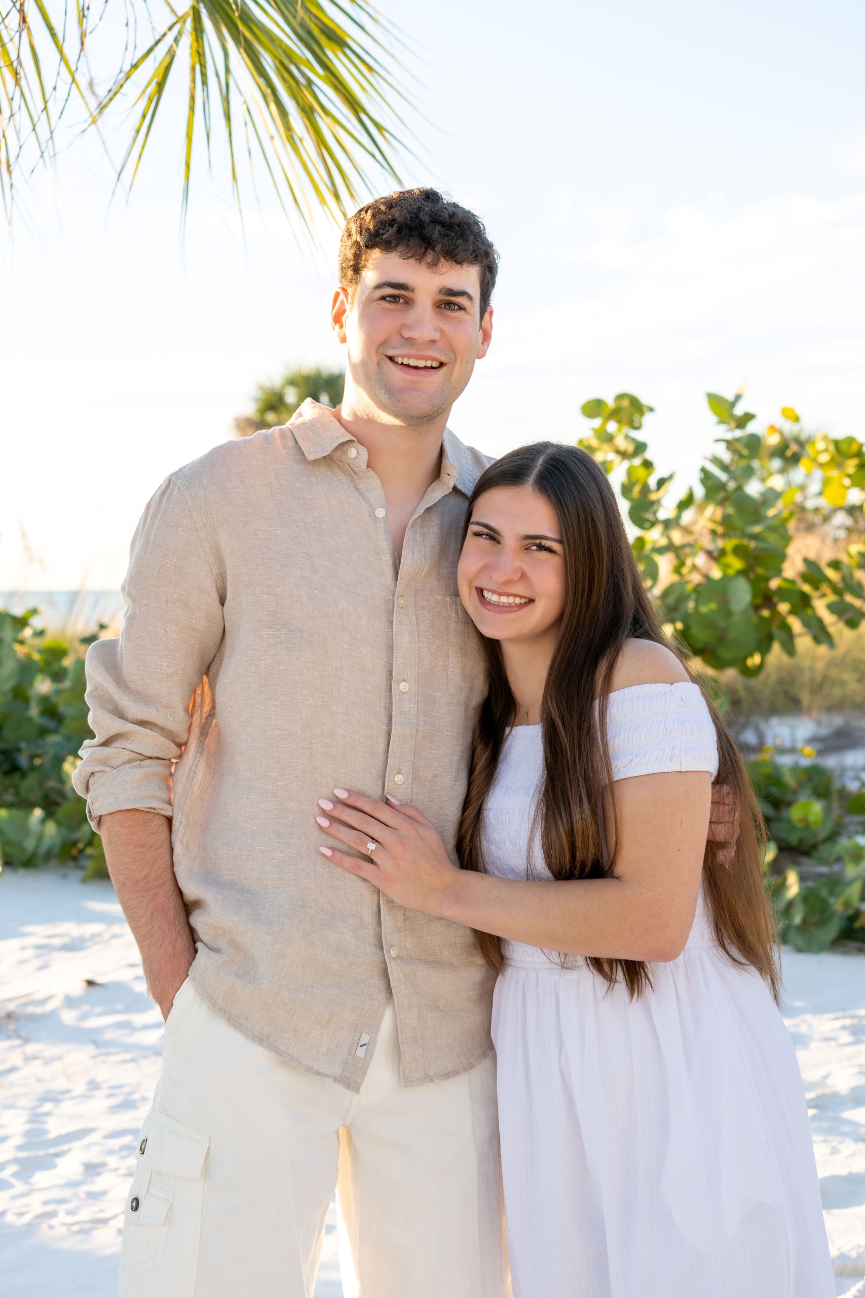 young couple snuggle in a hug and smile