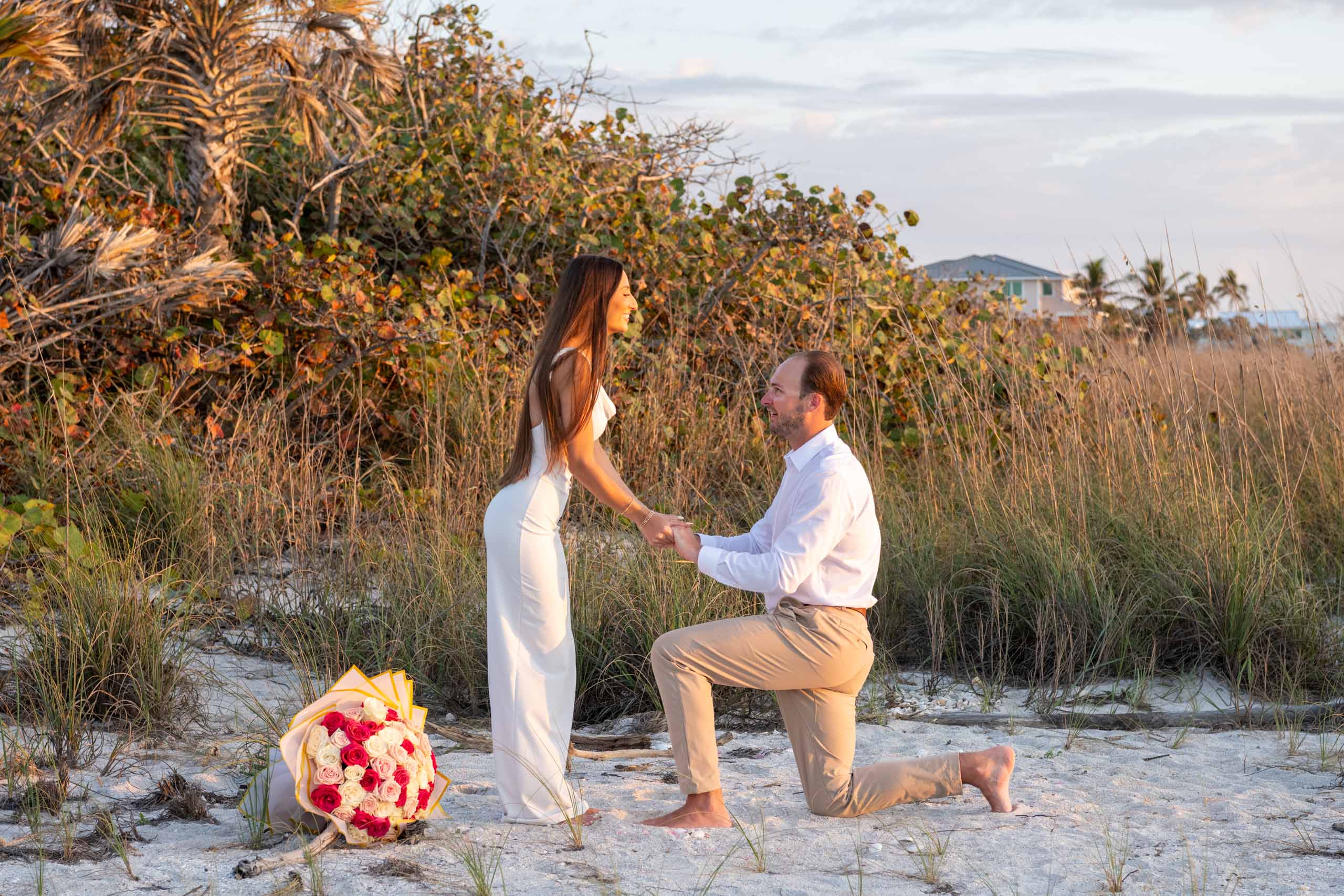 man down on his knee proposing to his girlfriend