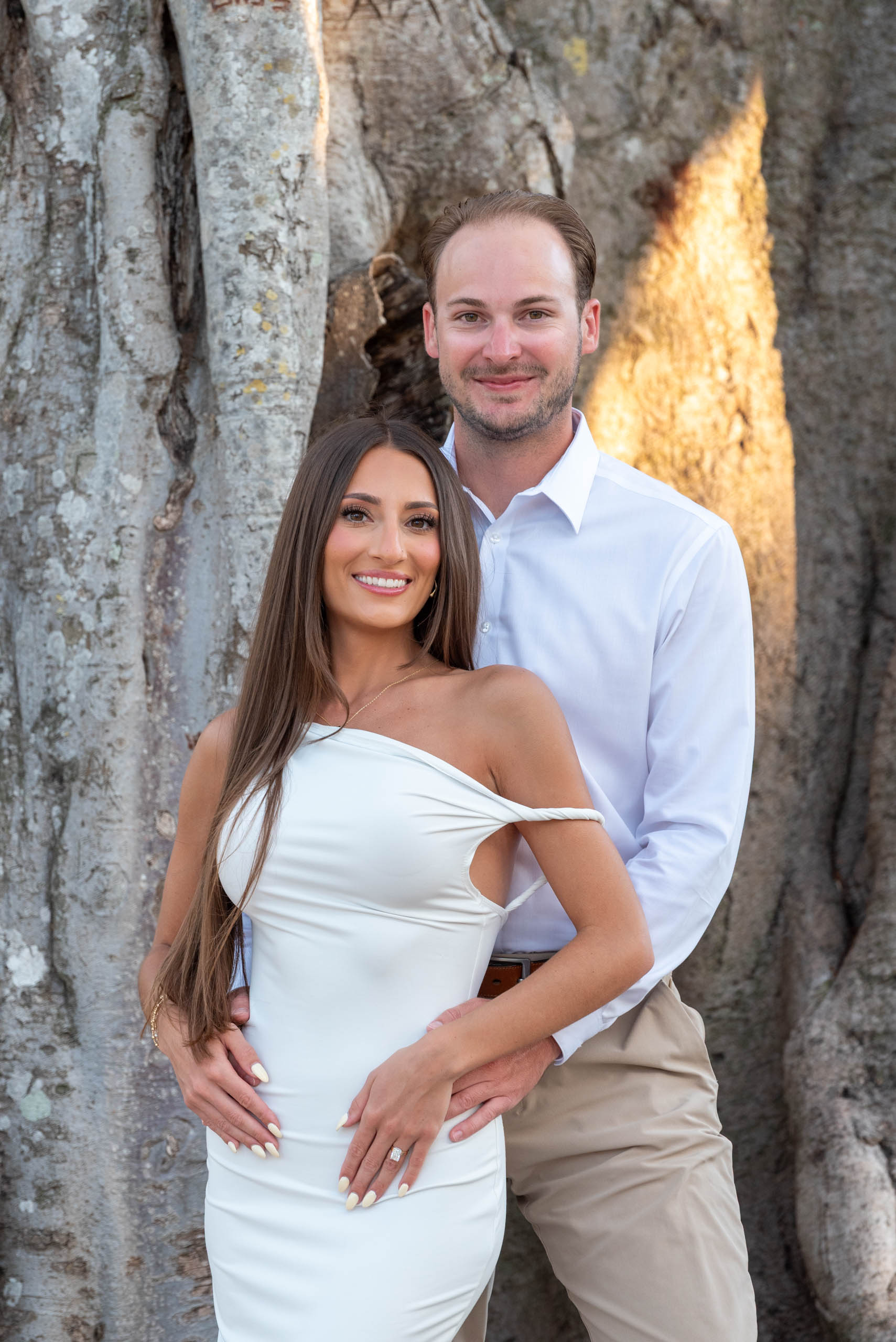 engaged couple in front of a banyan tree