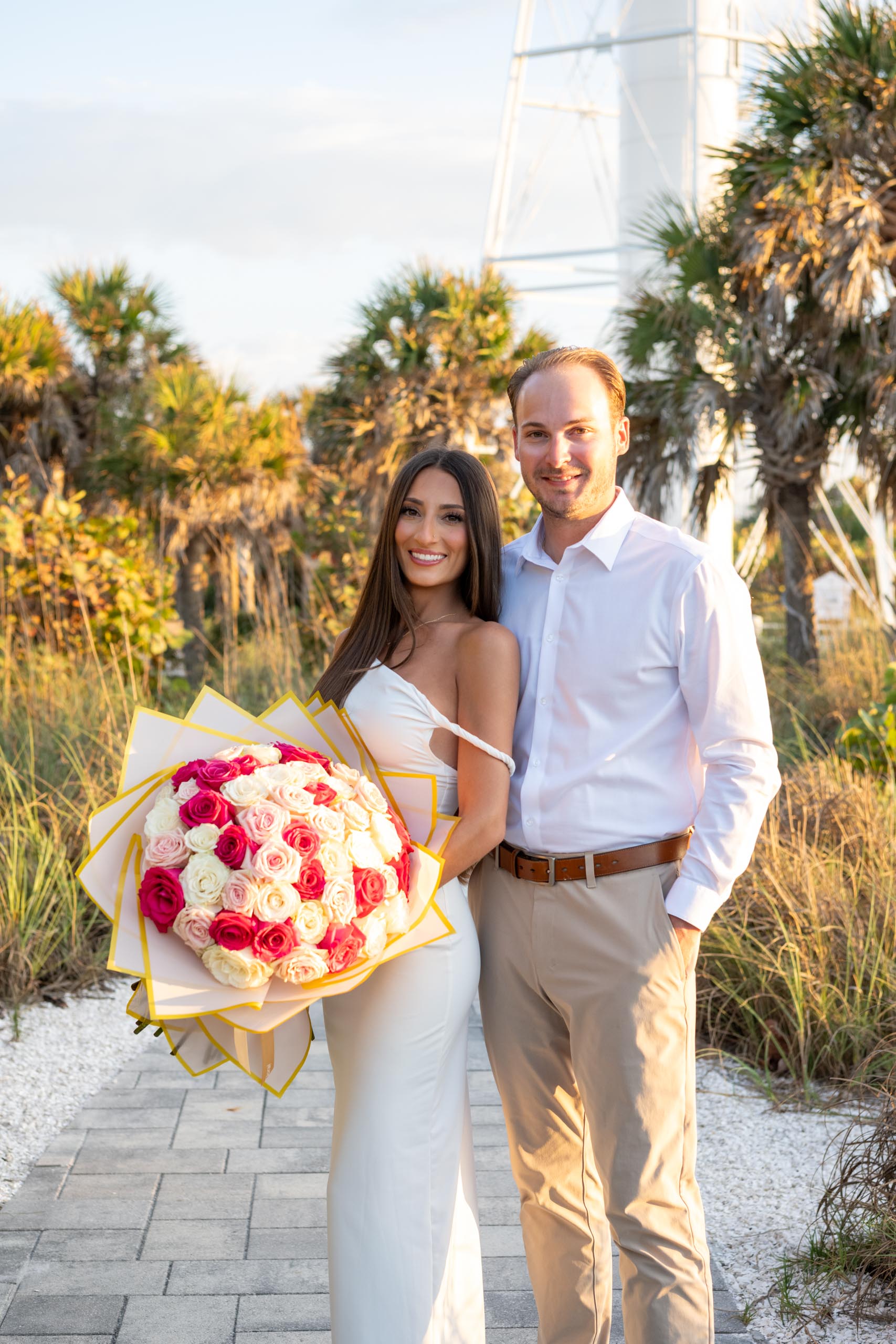 couple with roses by the Boca Grande lighthouse