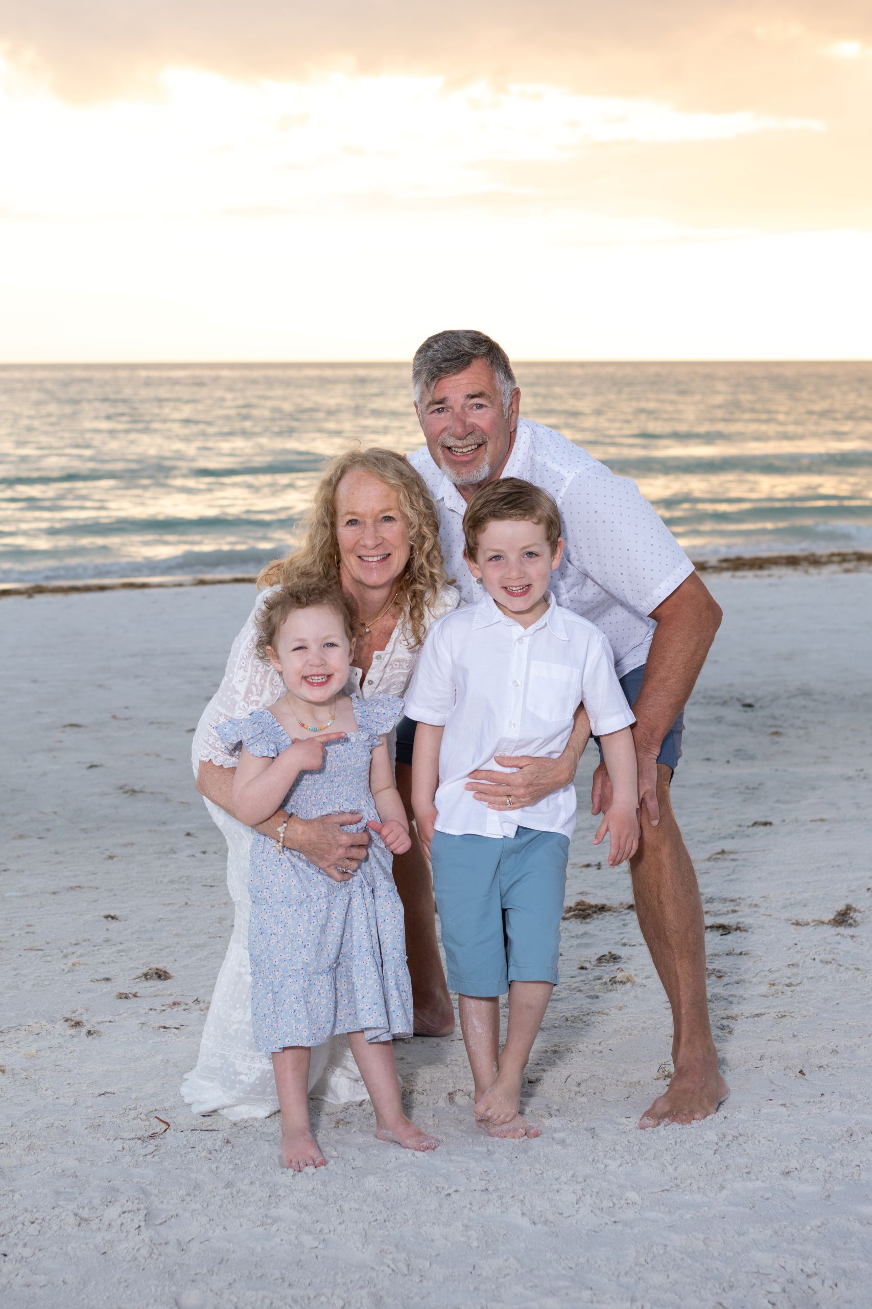 grandparents hug their grandchildren