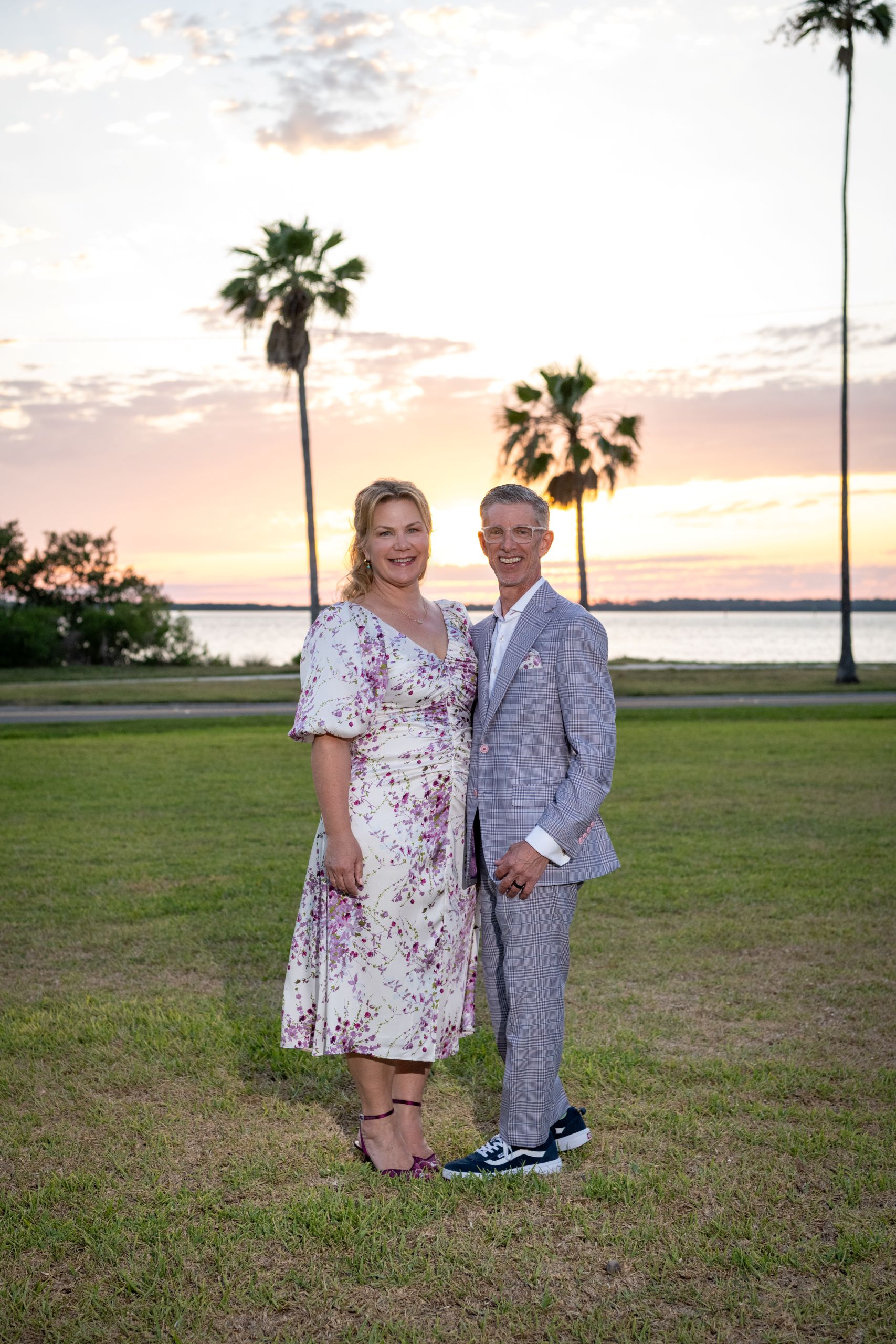 bride and groom on the front lawn at sunset of the Fenway Hotel