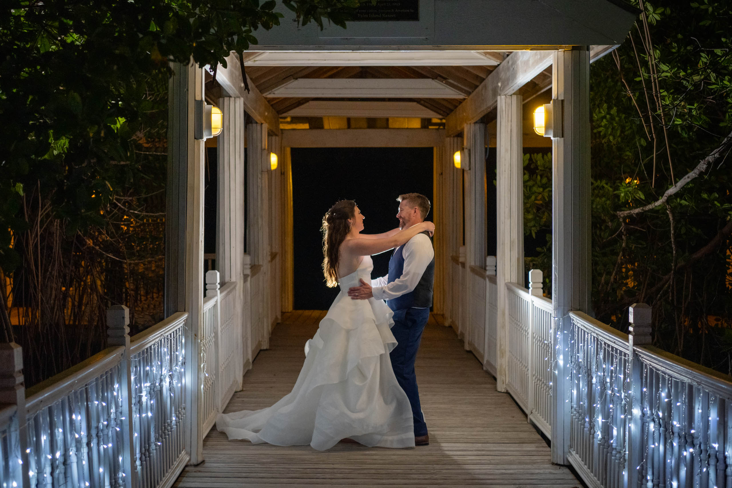 bride and groom dance close on the dock after dark during their wedding reception at Palm Island Resort
