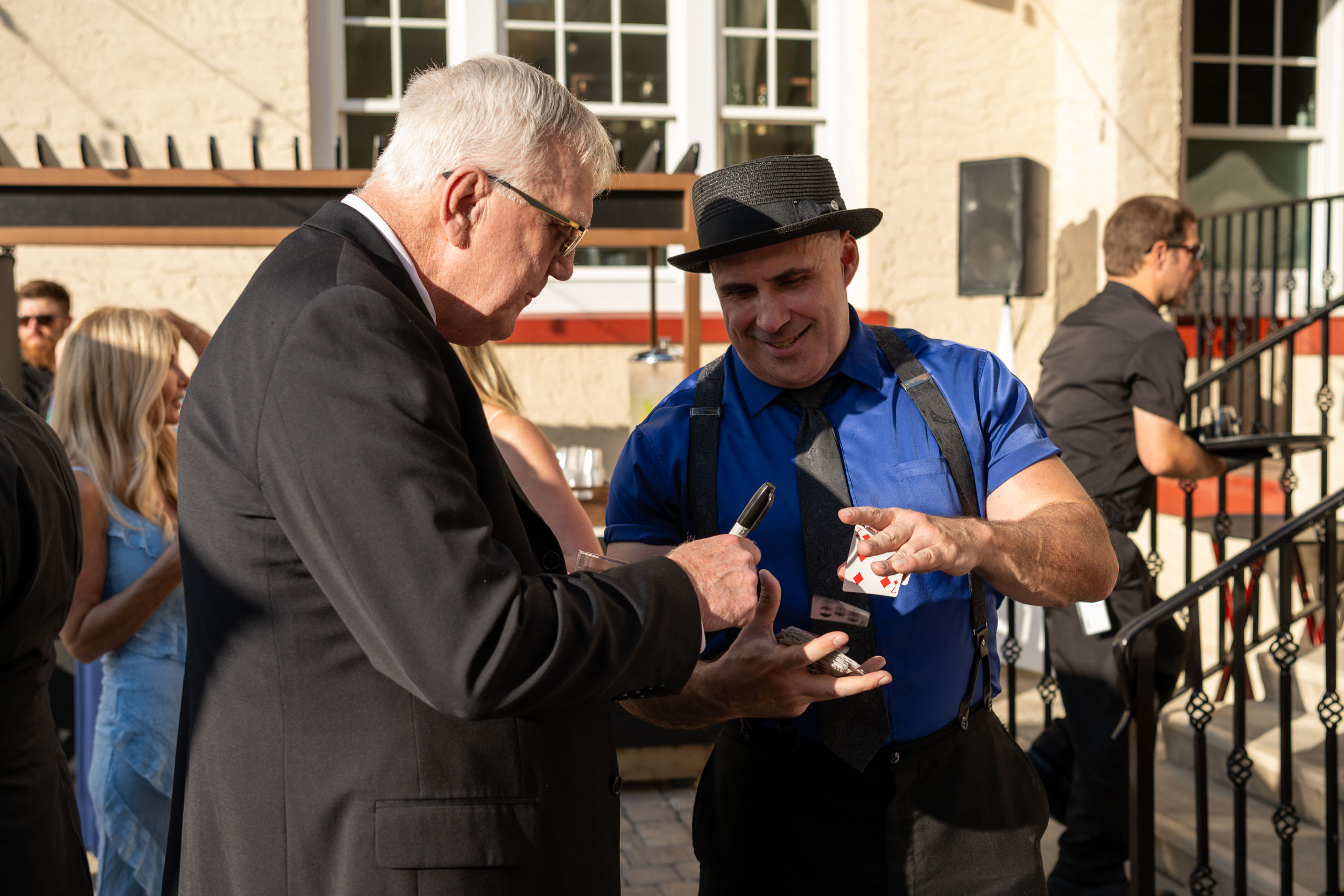 magician performing slight of hand during cocktail hour