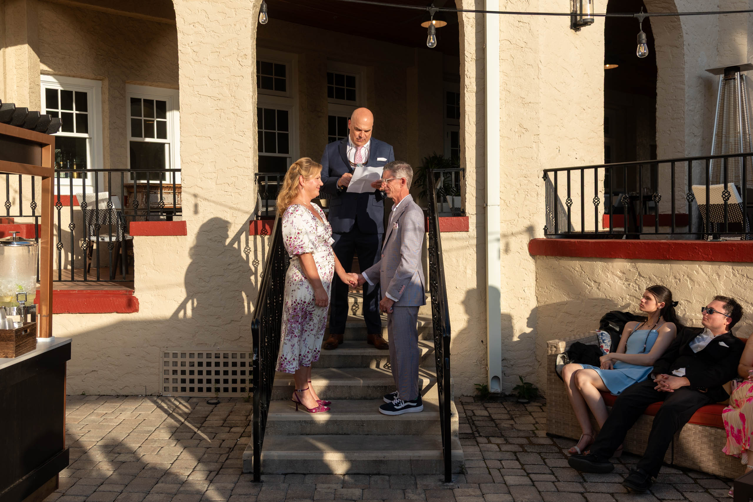 couple saying their vows on the steps of the Fenway Hotel