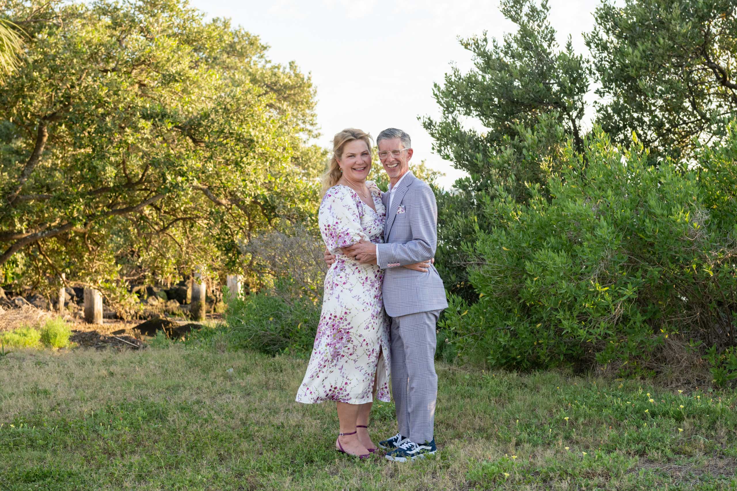 bride and groom pose for portraits in the grass