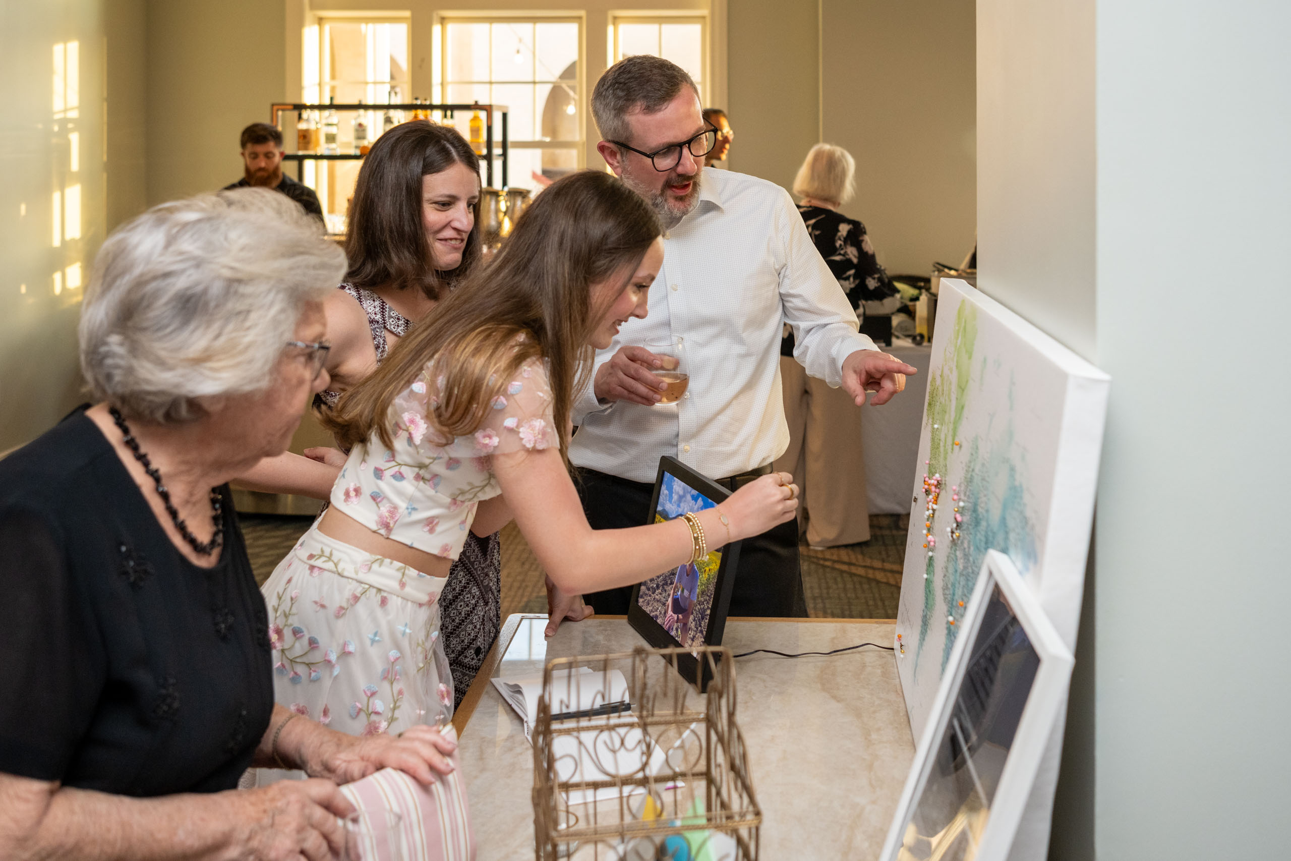guests sign the wedding guest book and place a pin on a board of the world to mark a special location
