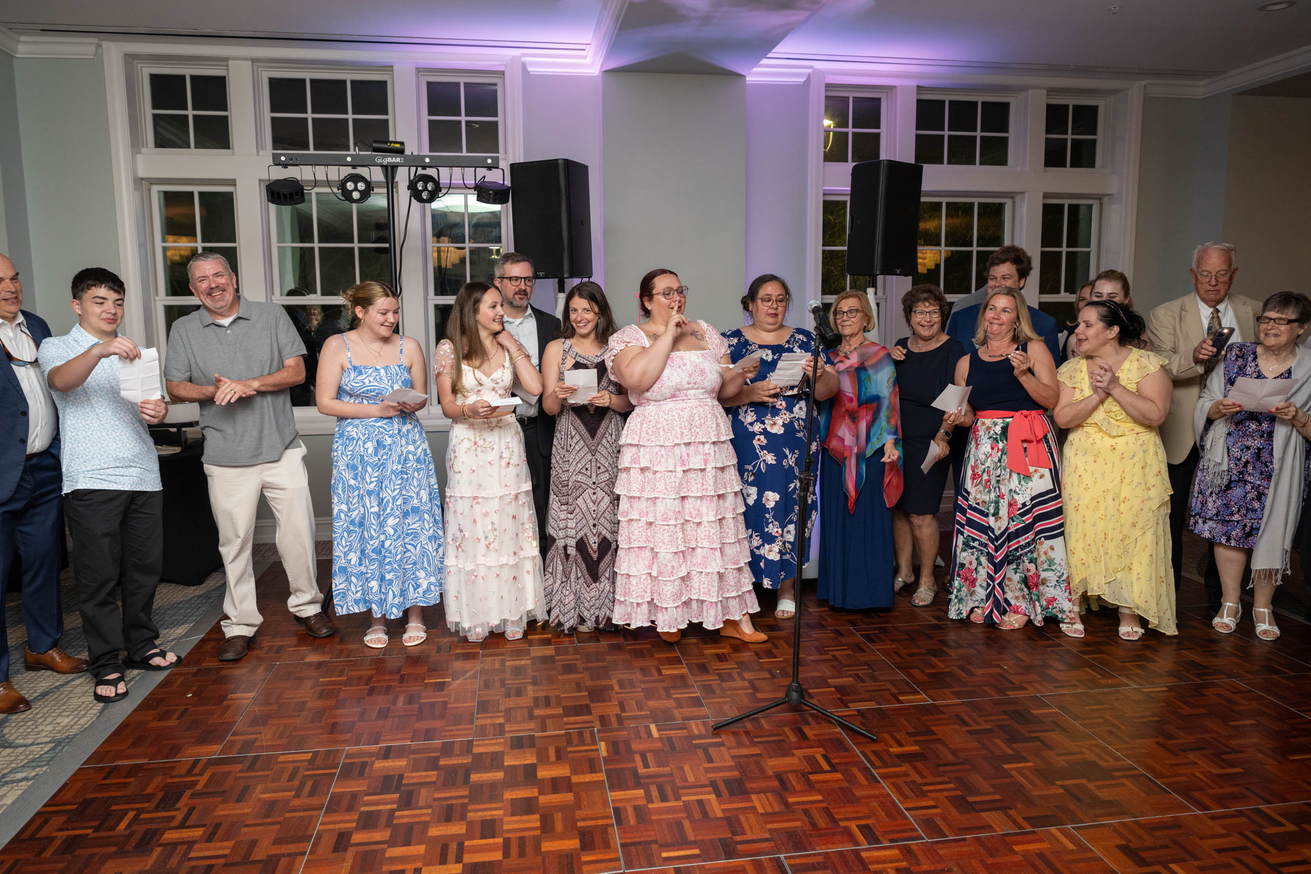 family gathered to sing a song during wedding reception